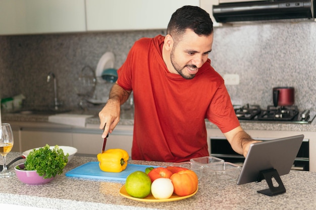 Hispanic Man Making A Video Conference From His Home Kitchen