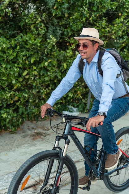 Hispanic man rides bike to work in the city