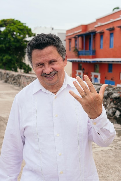 Hispanic man showing his wedding ring