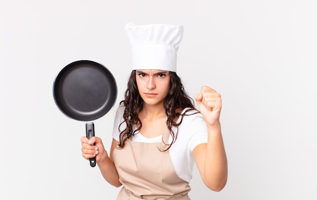 Hispanic pretty chef woman holding a pan