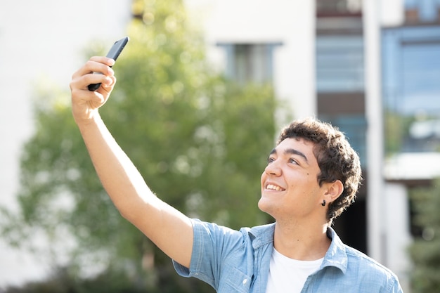 Hispanic teenager boy taking selfie