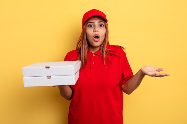 Hispanic woman amazed shocked and astonished with an unbelievable surprise take away deliver concept