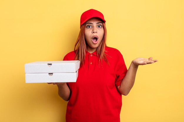 hispanic woman feeling extremely shocked and surprised. take away deliver concept