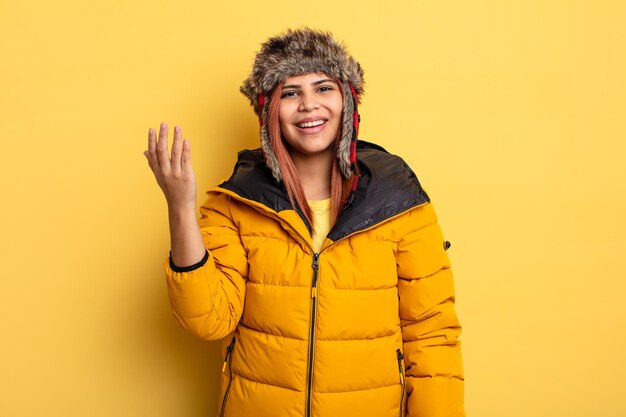 Hispanic woman feeling happy surprised realizing a solution or idea winter concept