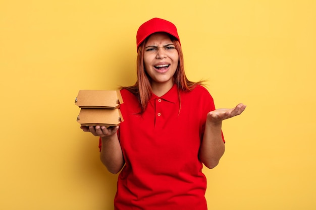 Hispanic woman looking angry, annoyed and frustrated. take away deliver concept