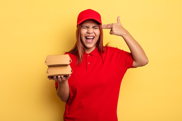 Hispanic woman looking unhappy and stressed, suicide gesture making gun sign. take away deliver concept