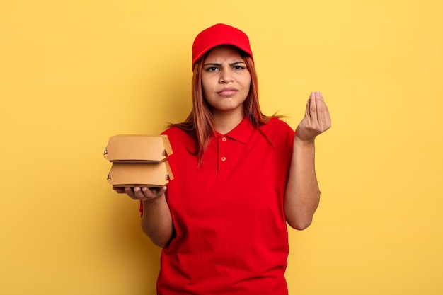 hispanic woman making capice or money gesture, telling you to pay. take away deliver concept