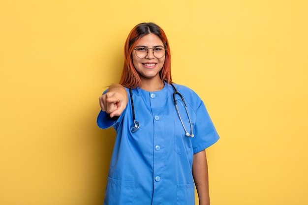 Hispanic woman pointing at camera choosing you. nurse concept