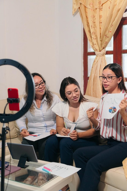 Hispanic women at an online conference Women entrepreneurs are analyzing the data table