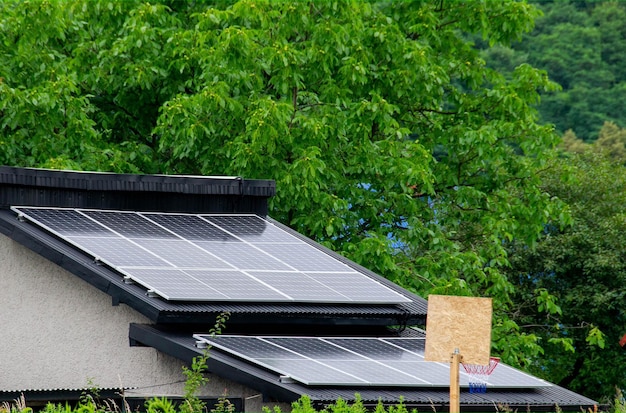 Historic farm house with modern solar panels on roof and wall