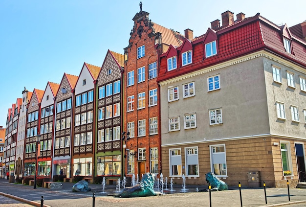 Historical buildings and fountain with lion sculptures in the old town of Gdansk, Poland