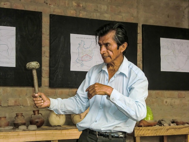 History teacher showing artifacts - ancient tools of the Incas in a museum in Peru.