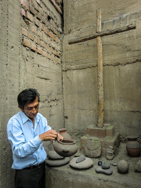 History teacher showing artifacts - ancient tools of the Incas in a museum in Peru.