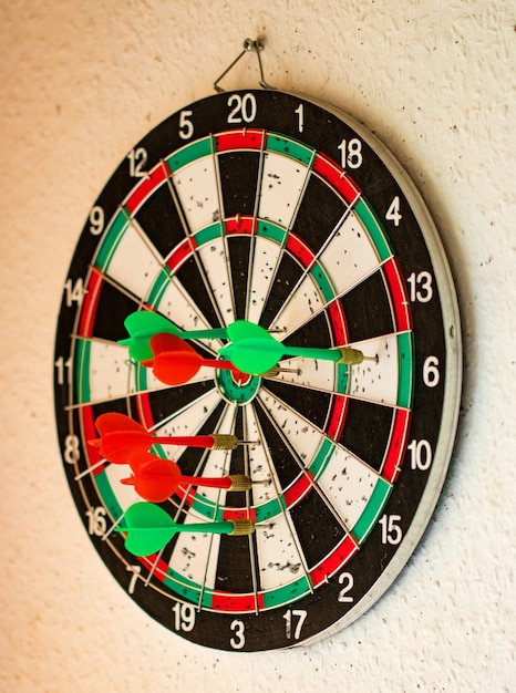 Hit group of target in dart game on wall.