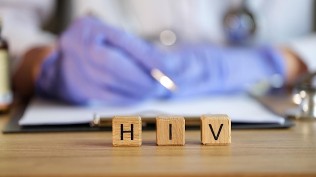 Hiv text on cubes in medical clinic against background of doctor human immunodeficiency virus