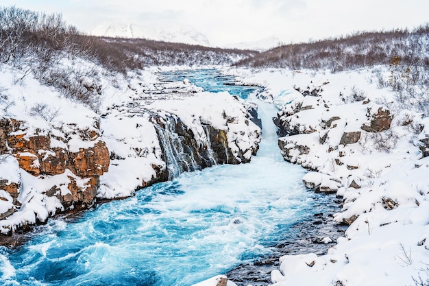 Hlauptungufoss Waterfall The 'Iceland's Bluest Waterfall' Blue water flows over stones Winter Iceland Visit Iceland Hiking to bruarfoss waterfall