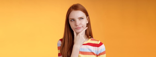 Hmm interesting suspicious doubtful attractive european redhead female pondering choice look hesitan