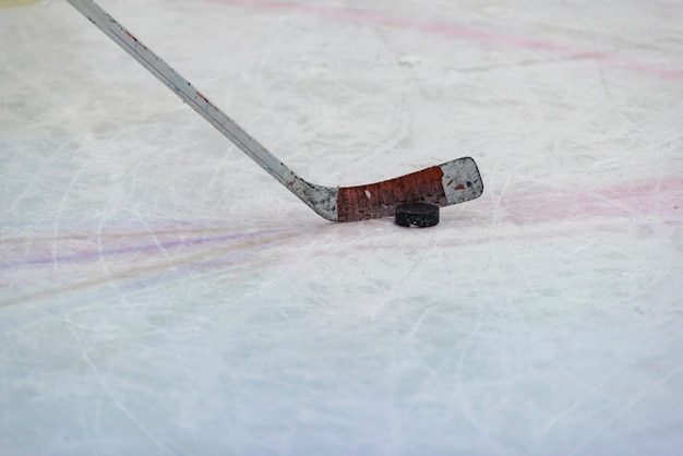 Hockey puck in front of the gate in front of the hockey game on ice