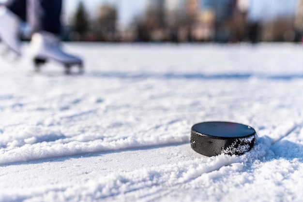 Hockey puck lies on the snow macro