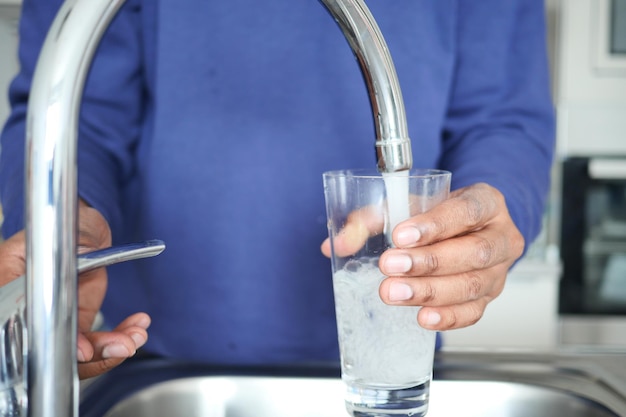 Holding dirty glass of water