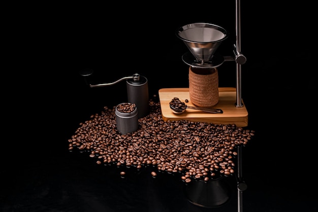 Holding drip coffee tools coffee grinder and roasted coffee beans on glass table