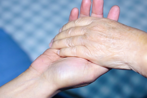 Holding hand Asian senior or elderly old lady patient with love