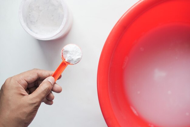 Holding a plastic spoon with a washing powder top view