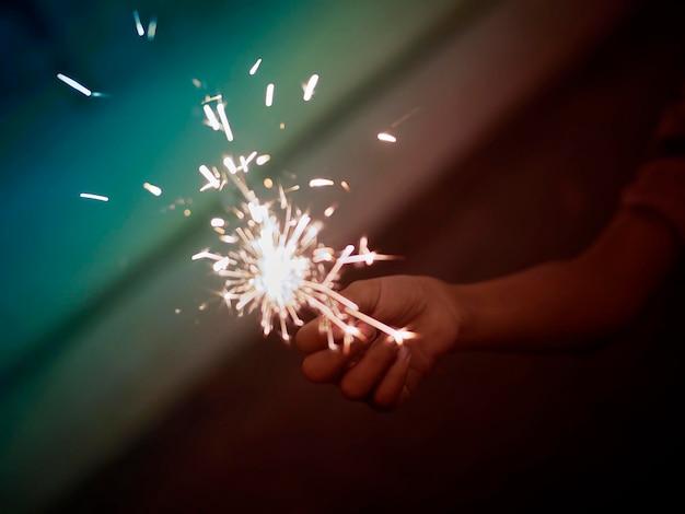 Holding a sparkler for special day BLUR BACKGROUND