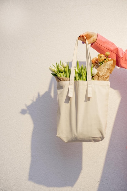 Holding tote bag with flowers