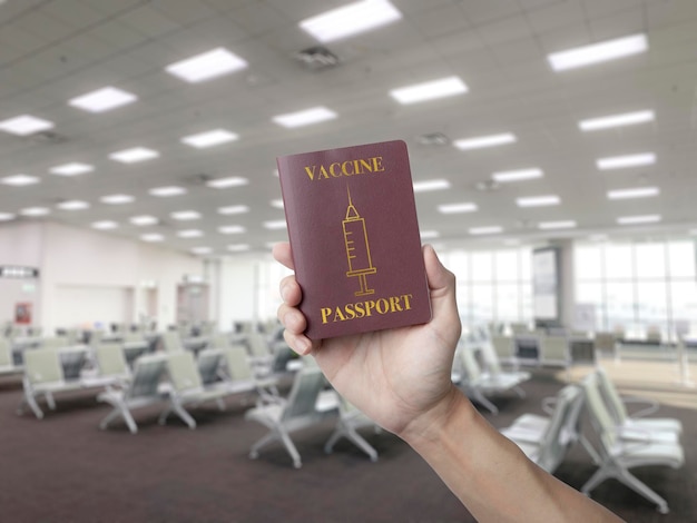 Holding a vacine passport at the airport terminal