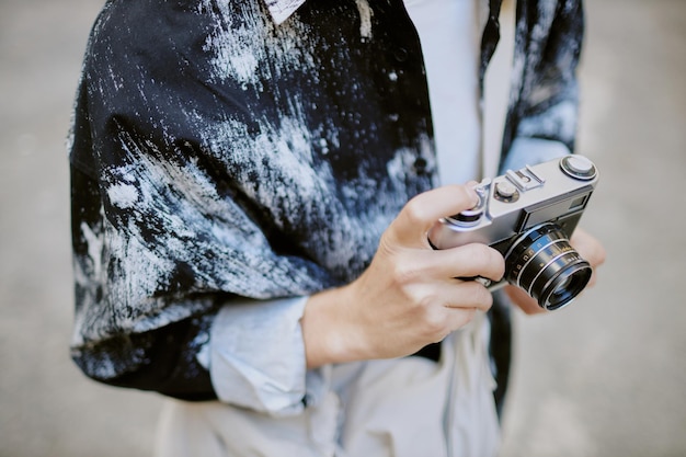 Photo holding vintage camera in comfortable blue shirt