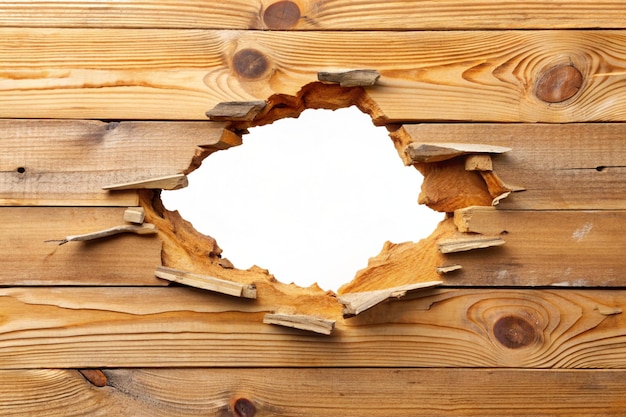 Hole breaking through white wooden wall cut out