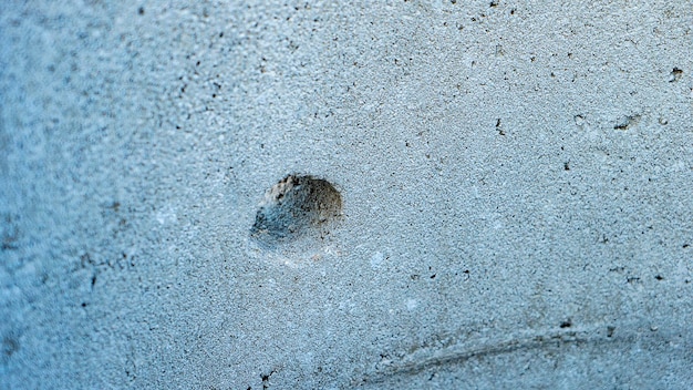 Hole for fastening in concrete block at construction site premium photo