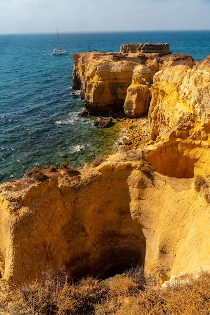 Holes in the beautiful coast in summer at Praia da Coelha Algarve Albufeira Portugal