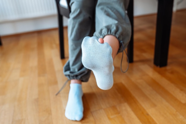 Holey sock on teenagers foot