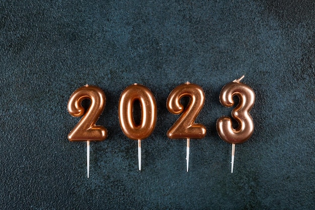 Holiday background Happy New Year Numbers 2023 made by gold candles