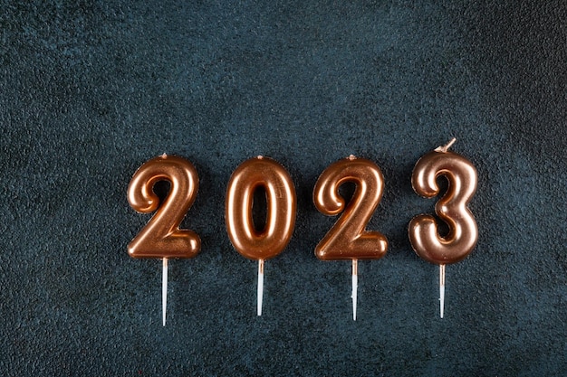 Holiday background Happy New Year Numbers 2023 made by gold candles