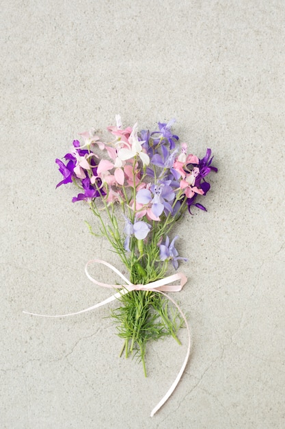 Holiday bouquet of wild flowers on grey copy space