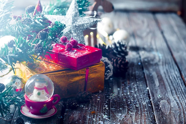 Holiday Boxes with beads on Wooden Background.