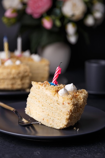 Holiday cake with crumbly shortcrust pastry and mini meringue Birthday cake with extinguished candles Homemade baking Black background selective focus closeup