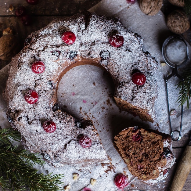 Holiday dessert Traditional homemade Christmas chocolate cake with cherry on wooden table