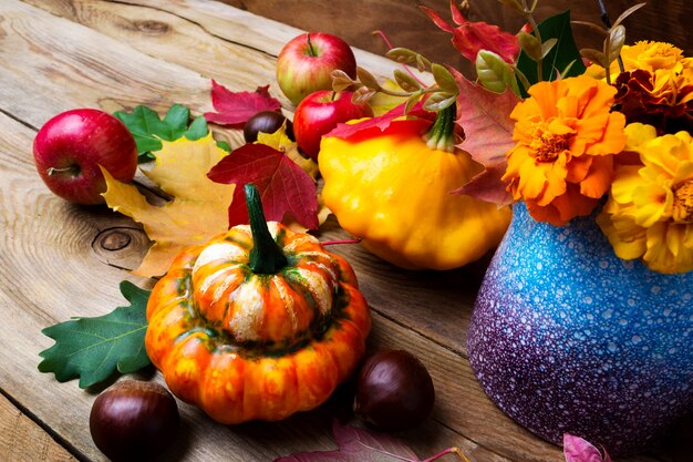 Holiday fall arrangement with pumpkin, chestnut and apples