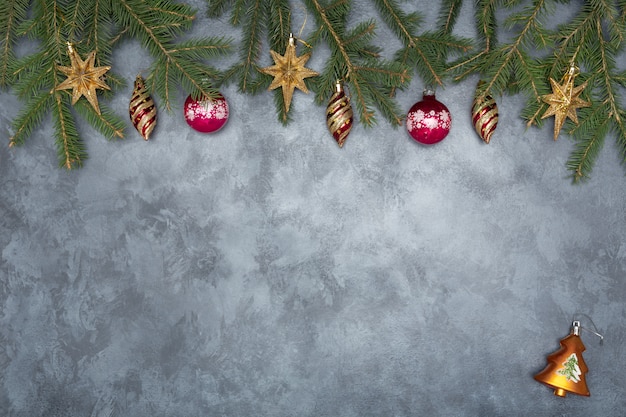 Holiday frame of Christmas decorations on blue dark stucco concrete