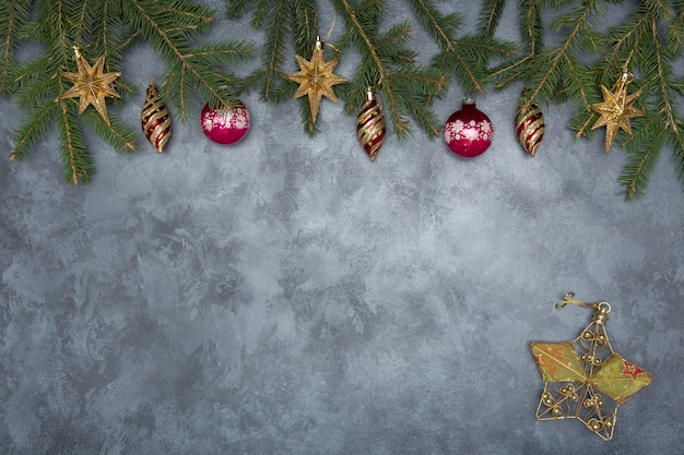 Holiday frame of Christmas decorations on blue dark stucco