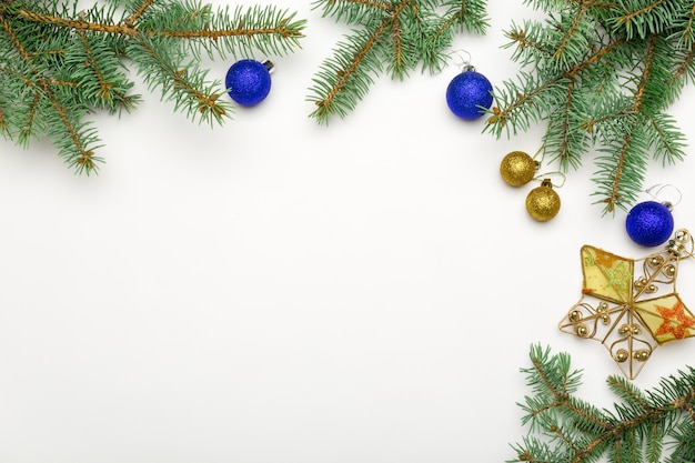 Holiday frame of Christmas decorations on white