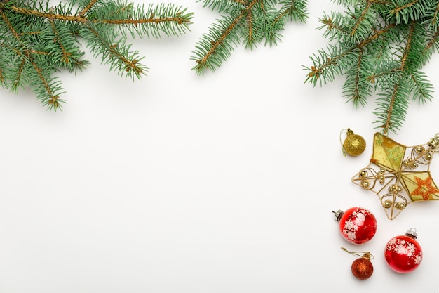 Holiday frame of Christmas decorations on white 