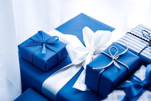 Holiday gifts and wrapped luxury presents blue gift boxes as surprise present for birthday Christmas New Year Valentines Day boxing day wedding and holidays shopping or beauty box delivery