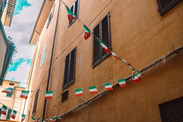 Holiday in the Italian city of streets with Italian flags and ancient buildingsPisa Italy