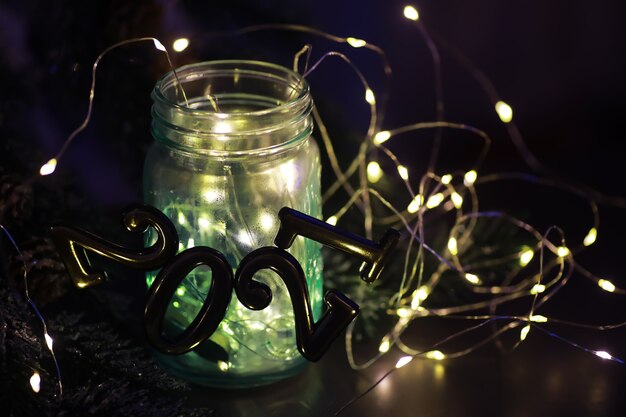 Holiday led light garland in jar. Christmas, new year holiday celebration concept. Copy space. Banner image for design