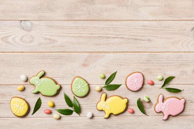 Holiday preparation Multi colors Easter eggs with cookies on colored background Pastel color Easter eggs holiday concept with copy space